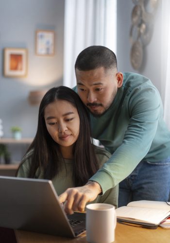 medium shot parents working from home